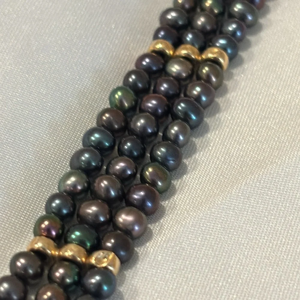 Tahitian black pearl bracelet with 14k gold filigree clasp.
